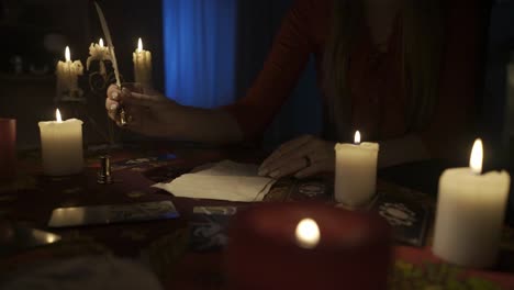 Woman Performing a Spiritual Ritual with Candles and Tarot Cards