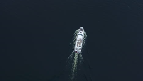 Top-view-of-luxury-boat-sailing-on-blue-ocean.-Aerial-view-of-yacht-sailing-sea