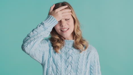 teenage caucasian girl doing face palm gesture in front of the camera.