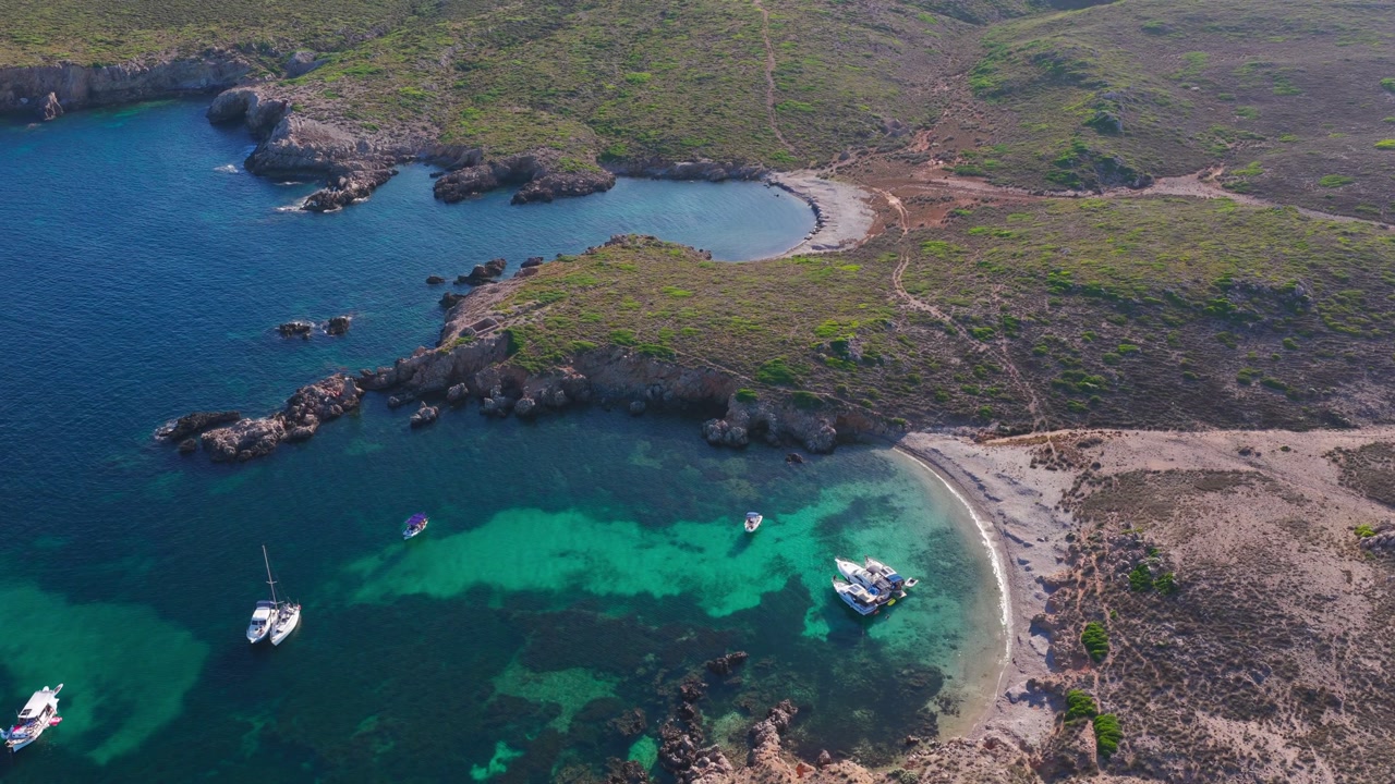 Aerial Flyover of Turquoise Sea and Rugged Coastline in Menorca, Spanish nature