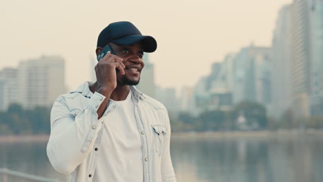 man talking on phone in city park