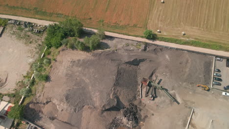 top view of a quarry next to an agricultural fields on northern province of italy during summer