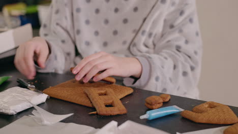 child making gingerbread house