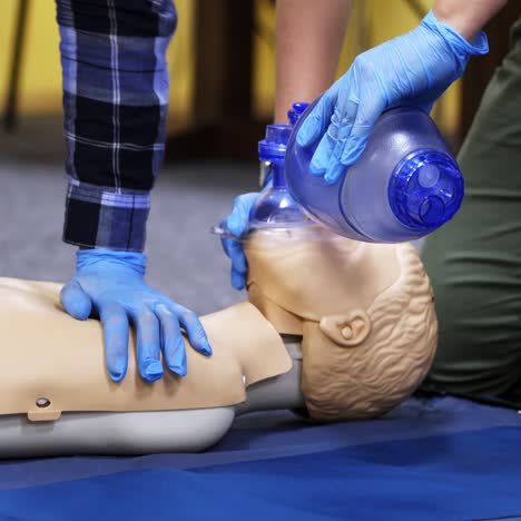 exercise for life saving in emergency. demonstration of cpr on manikin. teaching method pressing on the chest on a dummy in the medical room