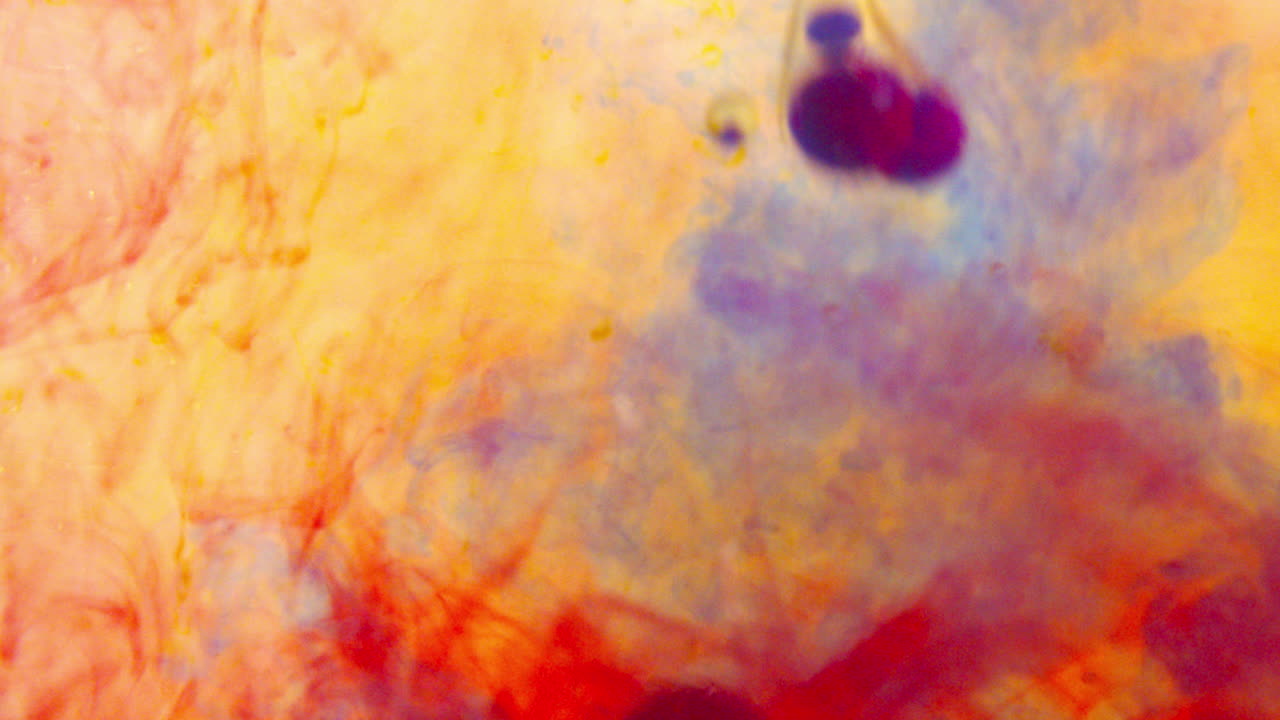 Red, yellow, and blue food coloring mixed with oil underwater