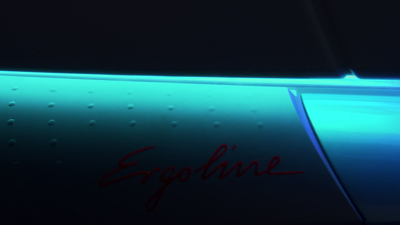 Close up of bright blue tanning sunbed and lid being opened and closed