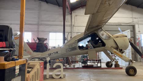 vintage airplane in a hangar workshop