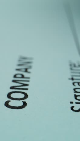 close-up of someone writing on light blue paper