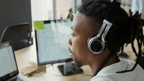 male executive working on computer at desk in office 4k