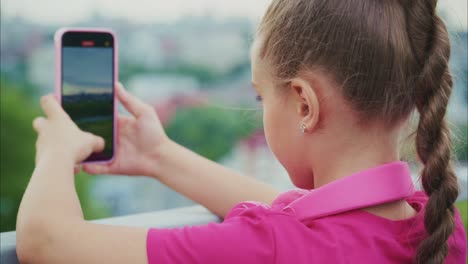 a young girl captures a beautiful sunset view with her smartphone, immersed in the joy of photography against a vibrant urban skyline