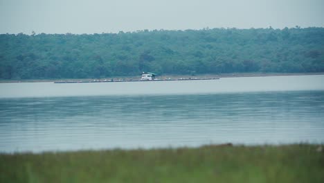 tranquil landscape with riverside hut, india. static