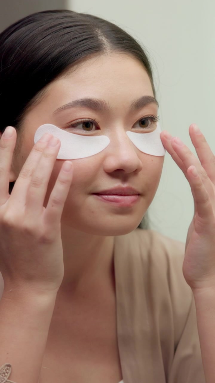 Young Woman Applying Under-Eye Patches for Skincare Routine