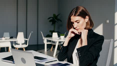 woman working at a laptop in a modern office