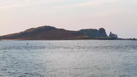 Evening-Serenity:-Two-People-Paddle-Boarding-near-Irelands-Eye-in-Howth,-Dublin