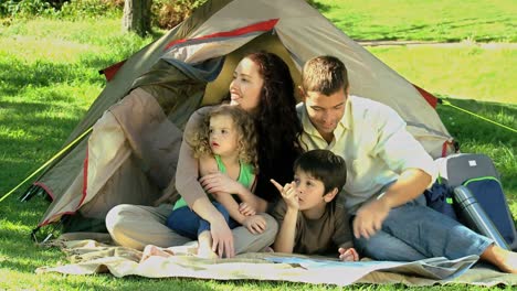 family looking at the landscape in front of the tent