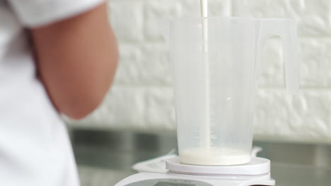 measuring milk for a recipe