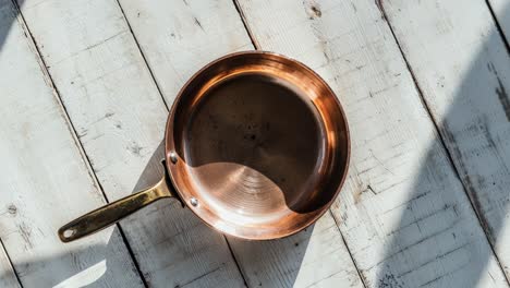 copper pan on white table