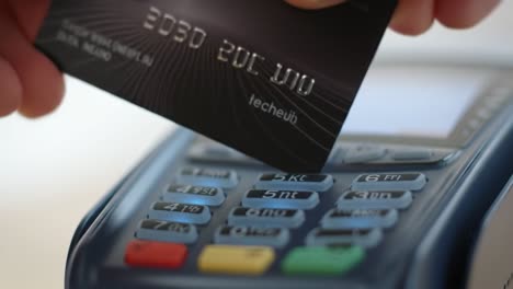 contactless payment process demonstrated with a credit card on a modern card reader near a soft focus background