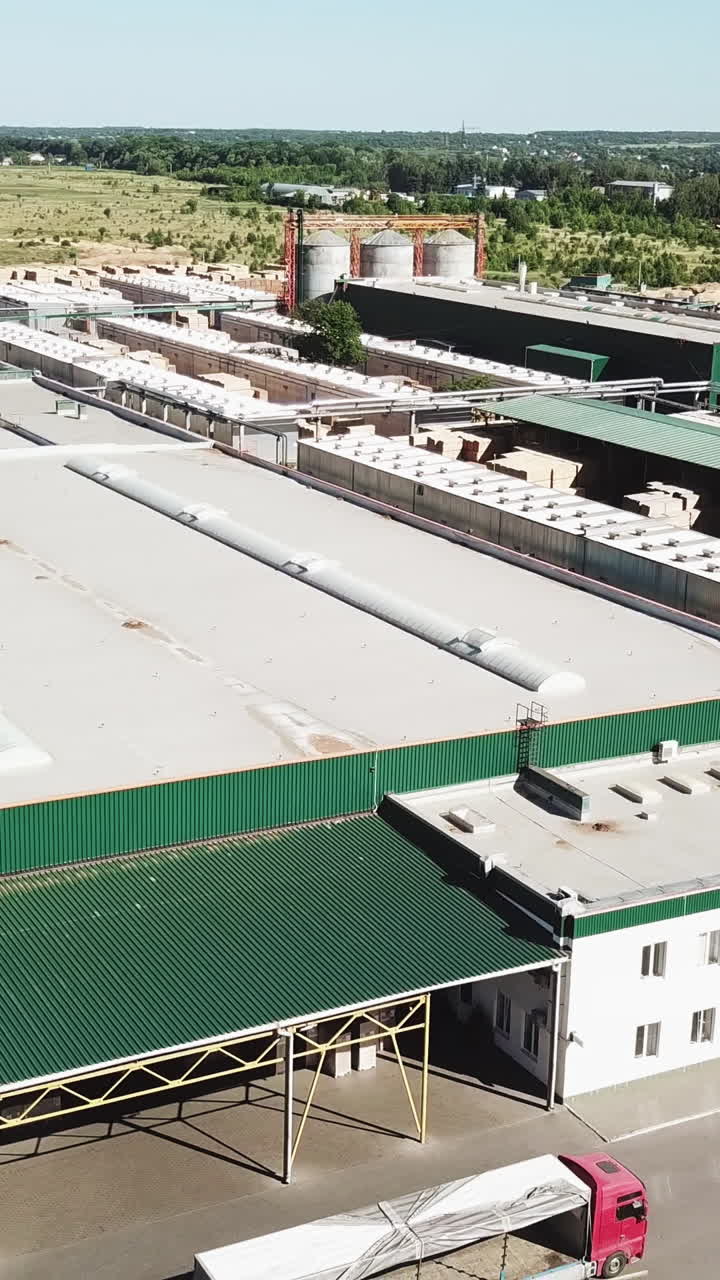 Aerial view of the woodworking factory outside the city. Camera motion to backwards Vertical video