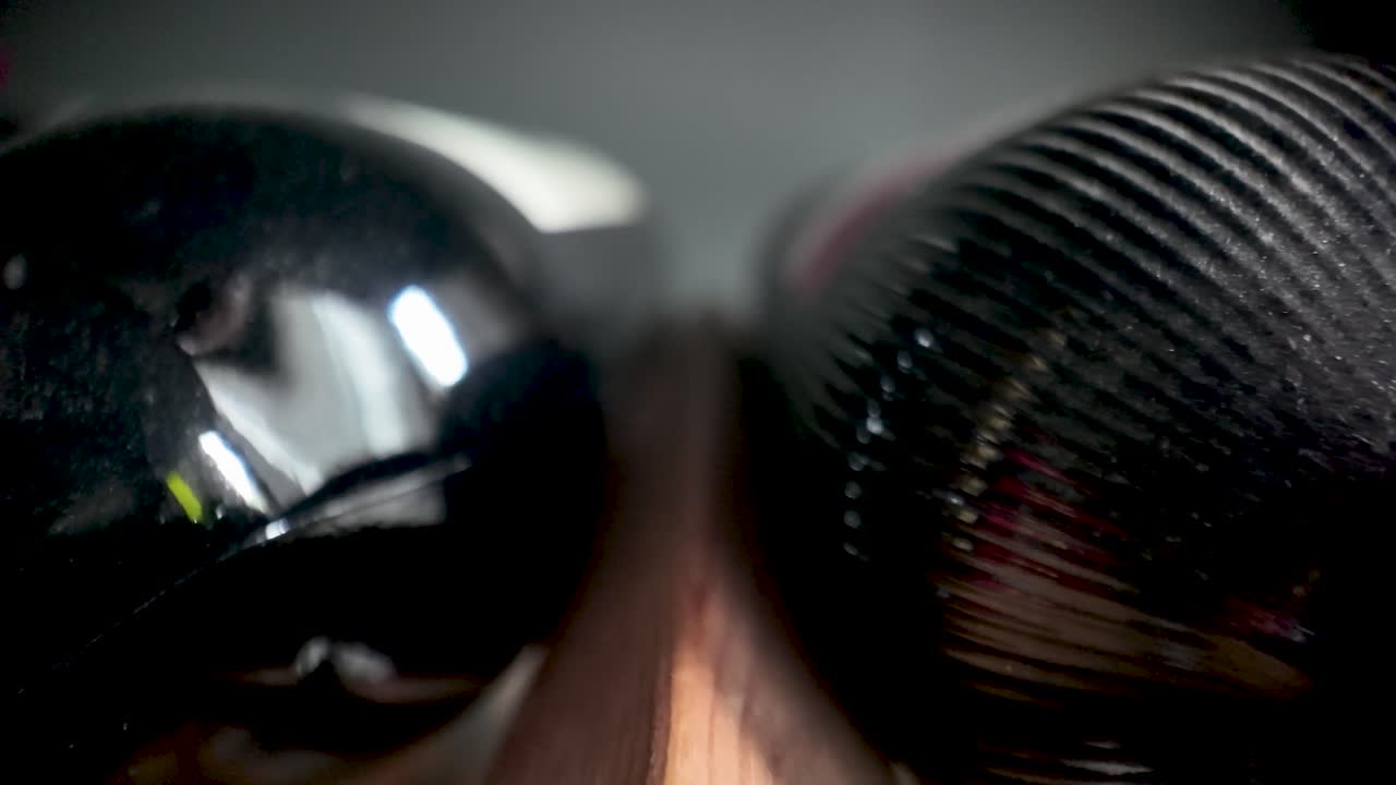 Wine bottles storing on a wooden rack, displaying aging process. close up, push forward shot