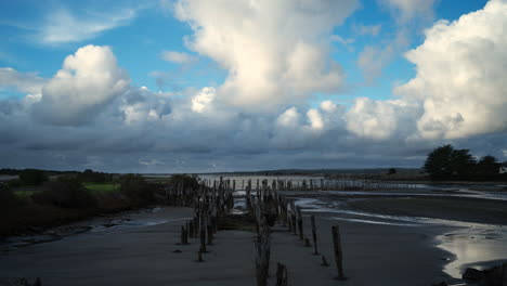 time lapse of pilings on coast side with approaching rain clouds