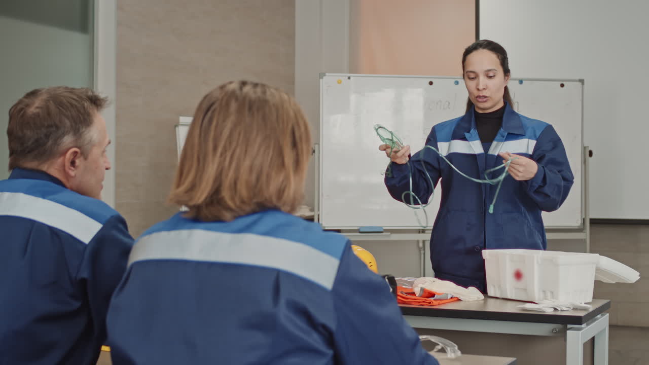Woman Giving Lecture On Safety Precautions At Factory