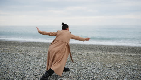 Woman Dances To Free Herself From Fears By The Sea In Overcast Day