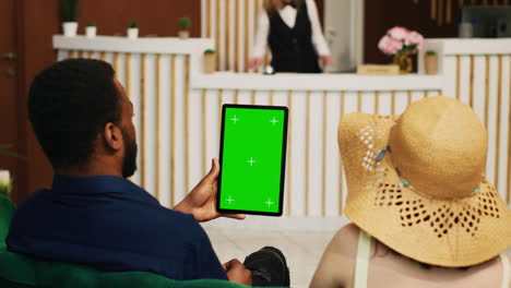 Guests-holding-tablet-with-greenscreen