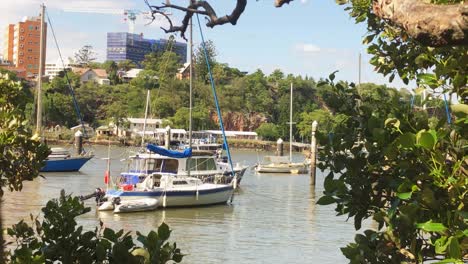 a boat sits rocking in the brisbane river