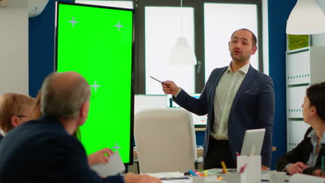 young man leader of company presenting financial strategy using green screen