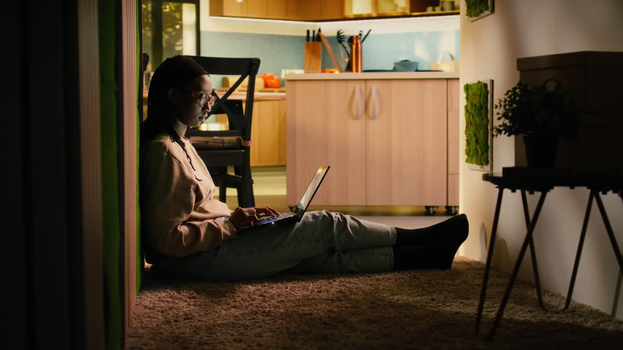 African american woman, with laptop on the floor, sitting and relaxing