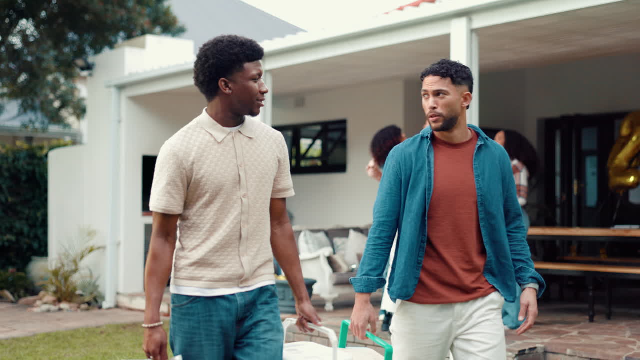 Two men grilling at an outdoor party
