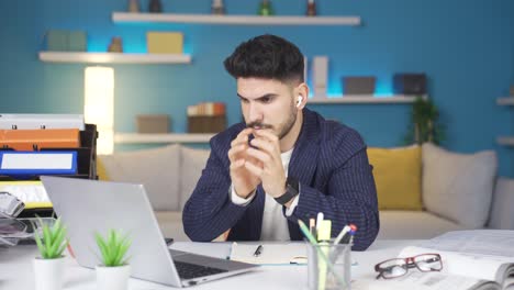 Businessman-nervously-looking-at-laptop,-occasionally-looks-at-his-watch.