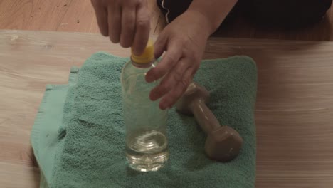 woman drinks water after workout