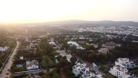 Drone-shot-beautiful-sunset-over-Spanish-city-and-town-in-mountains