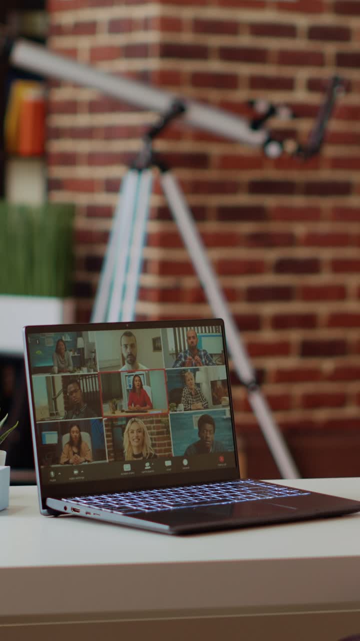 Vertical video Teleworking team leader in cozy apartment discussing with coworkers in videocall