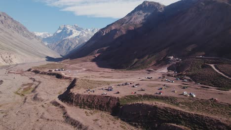 vehicles and tents at the camping area of termas valle de colina in cajon del maipo in chile