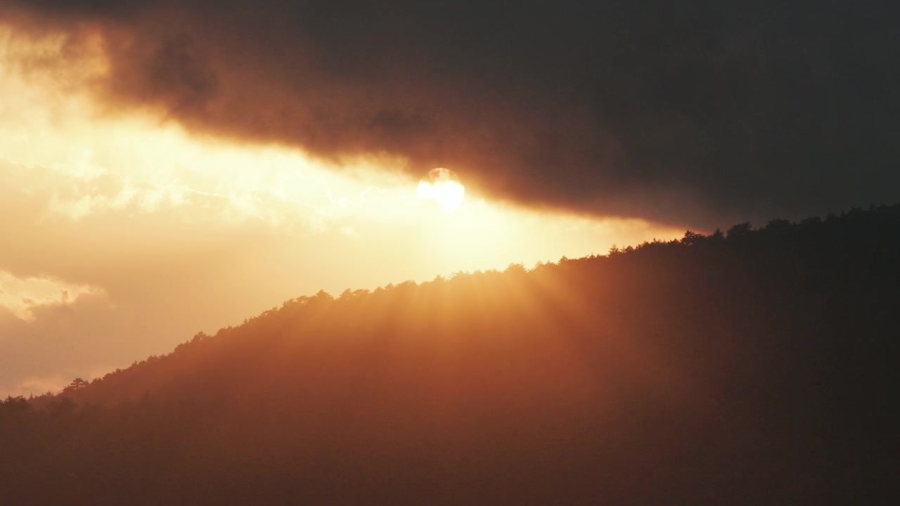 Dramatic golden sunset over Mount Pinos mountains in Southern California aerial captured with smooth cinematic drone footage