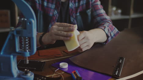 craftsman making wallet