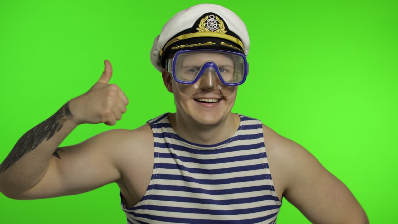 Emotional man tourist in underwater mask waving hands, striped sailor shirt