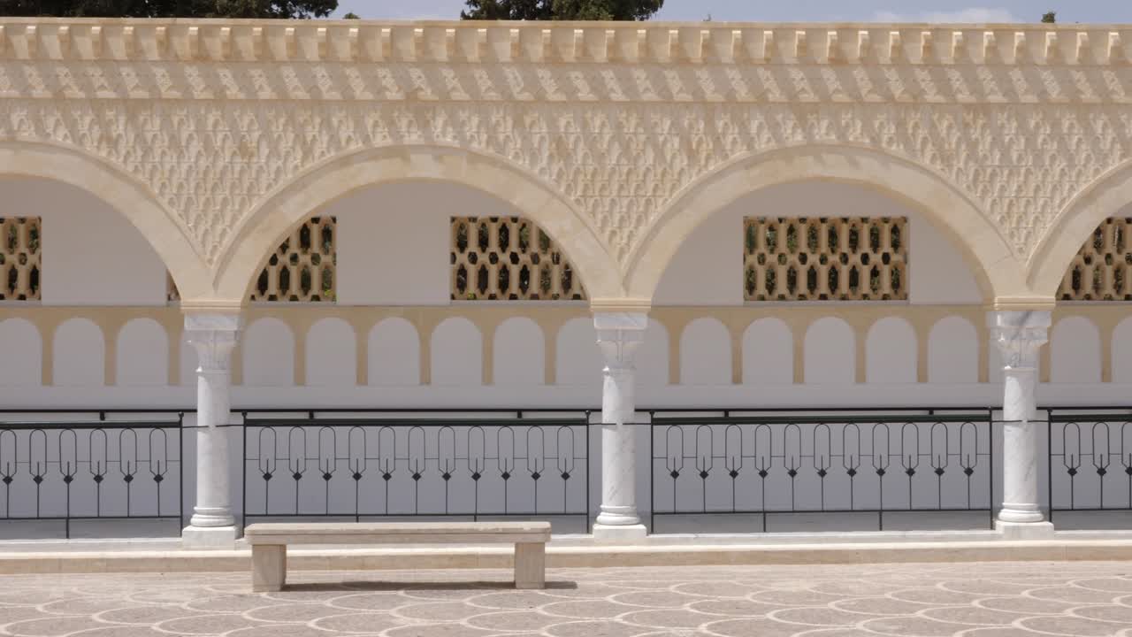 Panorama rows columns with arches on square Habib Bourguiba in Monastir Tunisia. Dolly shot exterior
