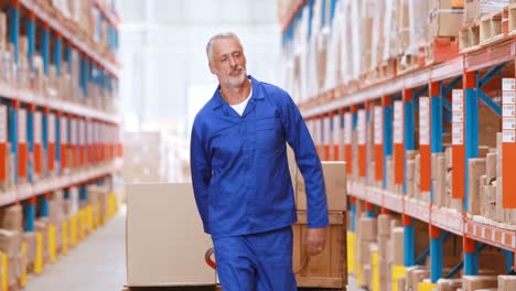 male warehouse worker using pallet truck