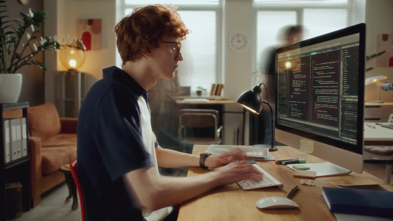 Time Lapse of Young Developer Typing Code on Computer at Modern Office Desk