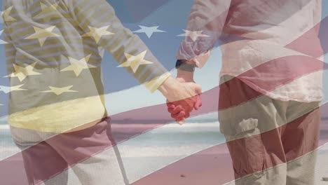 animación de una pareja caucásica de alto nivel cogida de la mano en la playa sobre la bandera de los estados unidos de américa