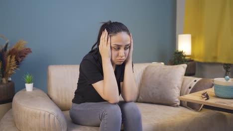 desperate young woman with her hands on her head. depressed.