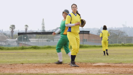 multiracial female baseball players, catching and throwing the ball, running on a pitch