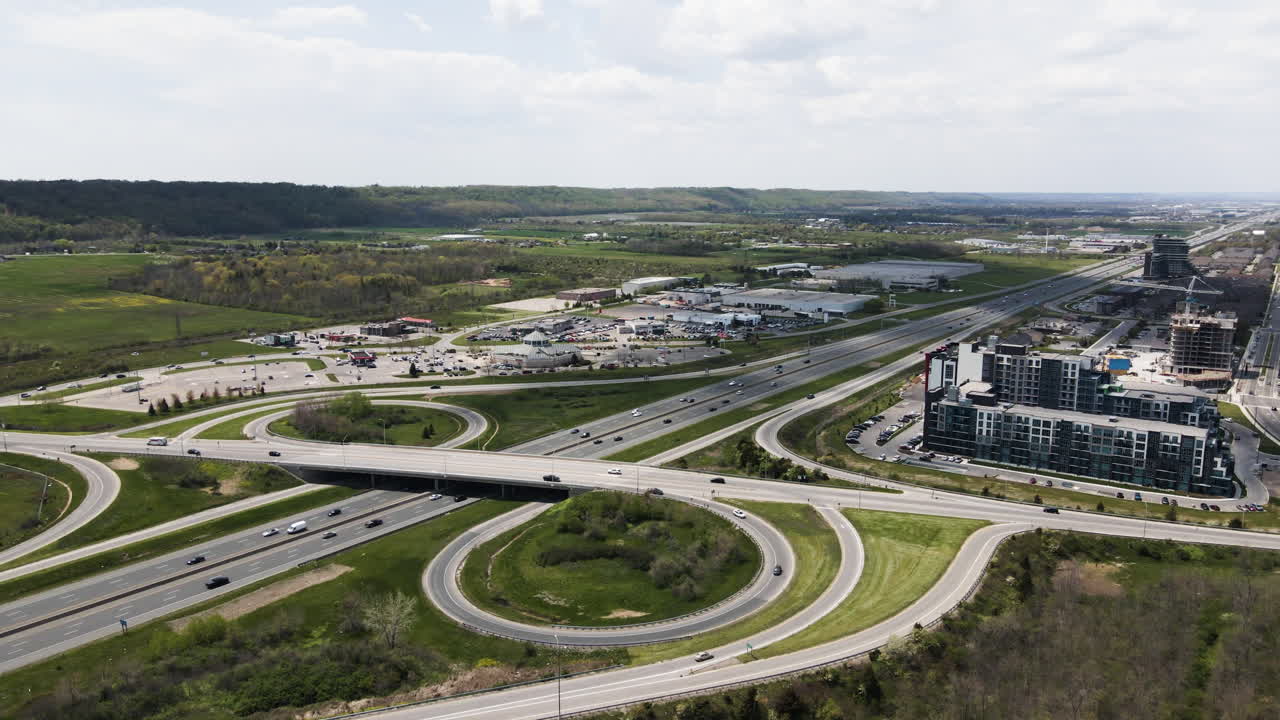 Aerial drone view of highway multi-level junction road with cars during sun. Cars driving on a multi-level road junction. Hamilton,Ontario, Canada