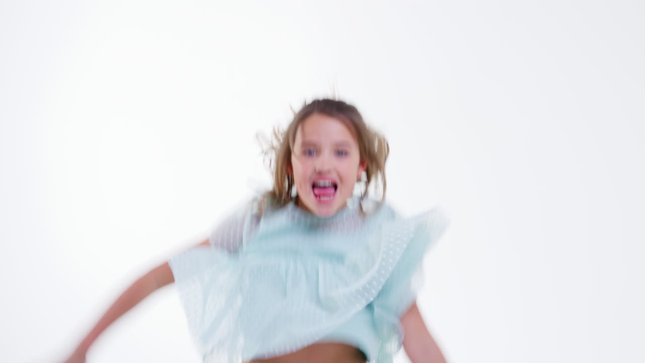 Young Girl Dancing Against White Background In Slow Motion