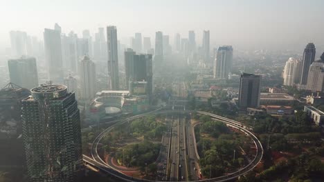 jakarta, indonesia. september 14, 2017: stunning aerial scenery footage of semanggi bridge and skyscrapers in misty morning