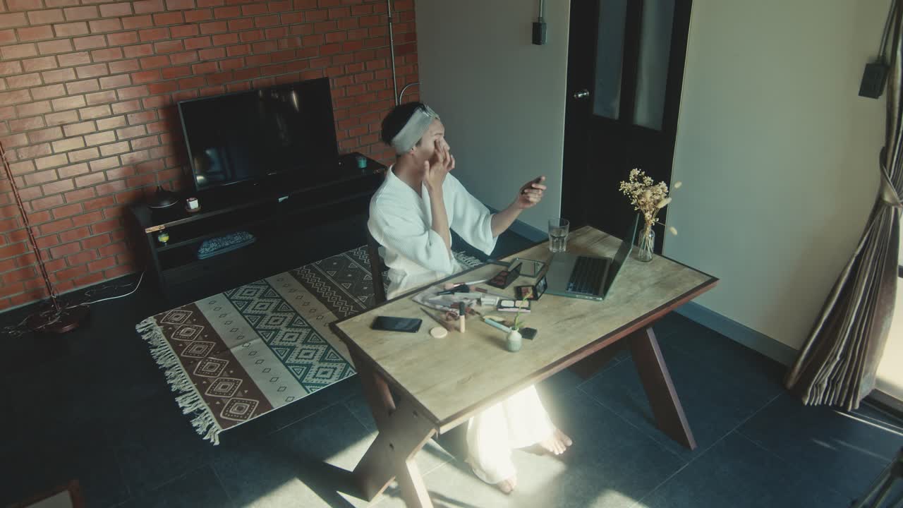 Woman Applying Makeup While Video Chatting